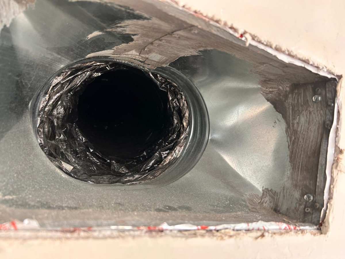 New galvanized vent boot connected to new insulated flex duct